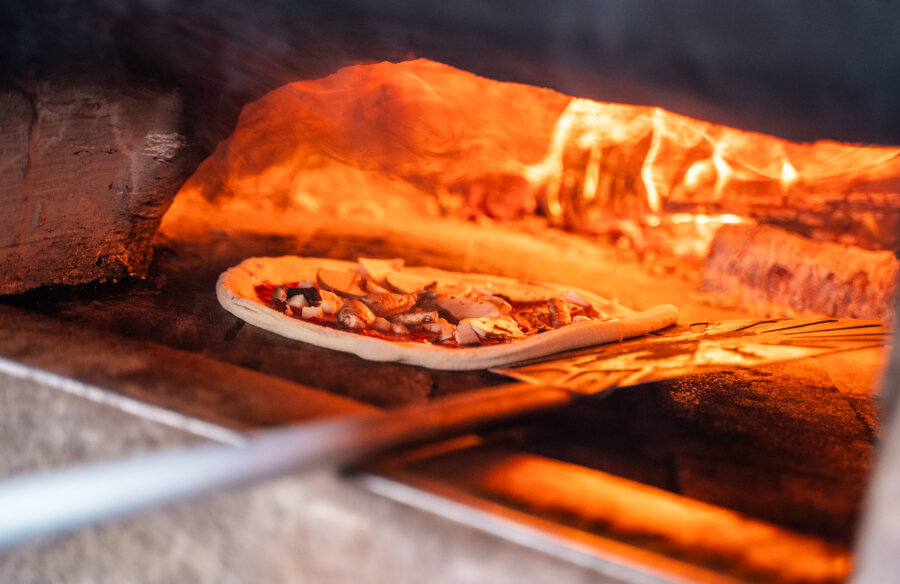 pizza cooking in a pizza oven