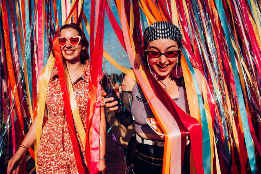 Two people walking under streamers 