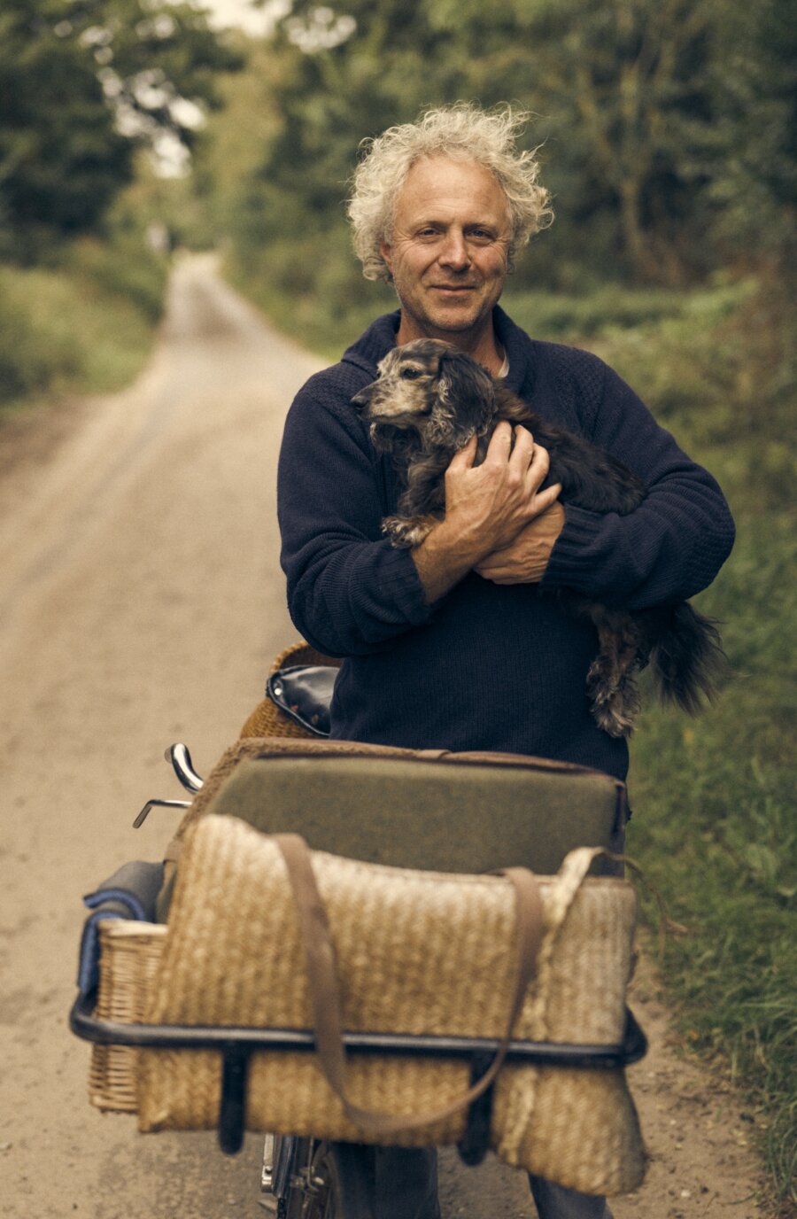Charlie Mackesy holding a dog