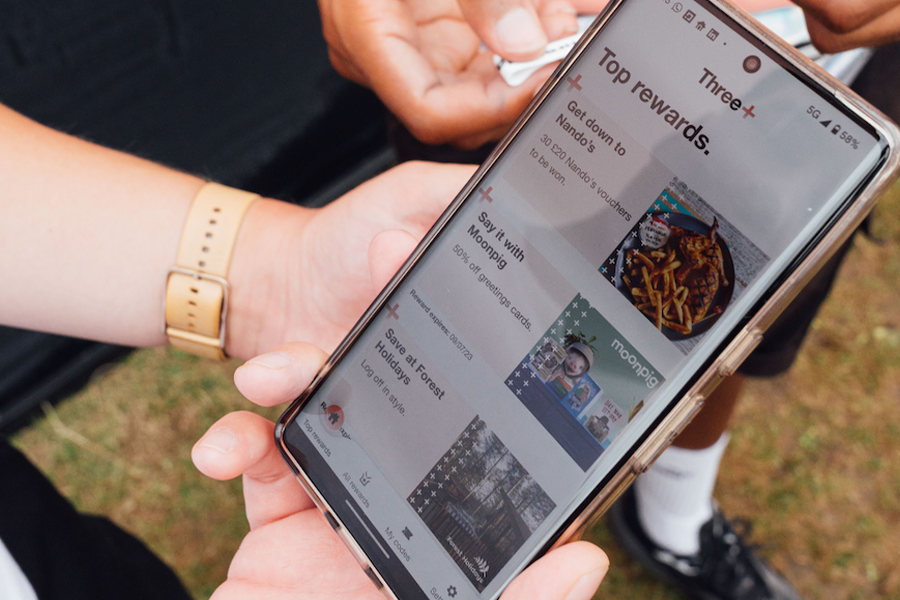a close up of a phone on the three rewards app