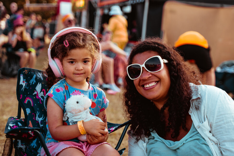 a mother with her child who is wearing ear defenders