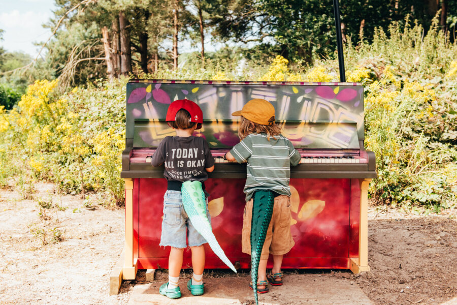 two children playing at the piano