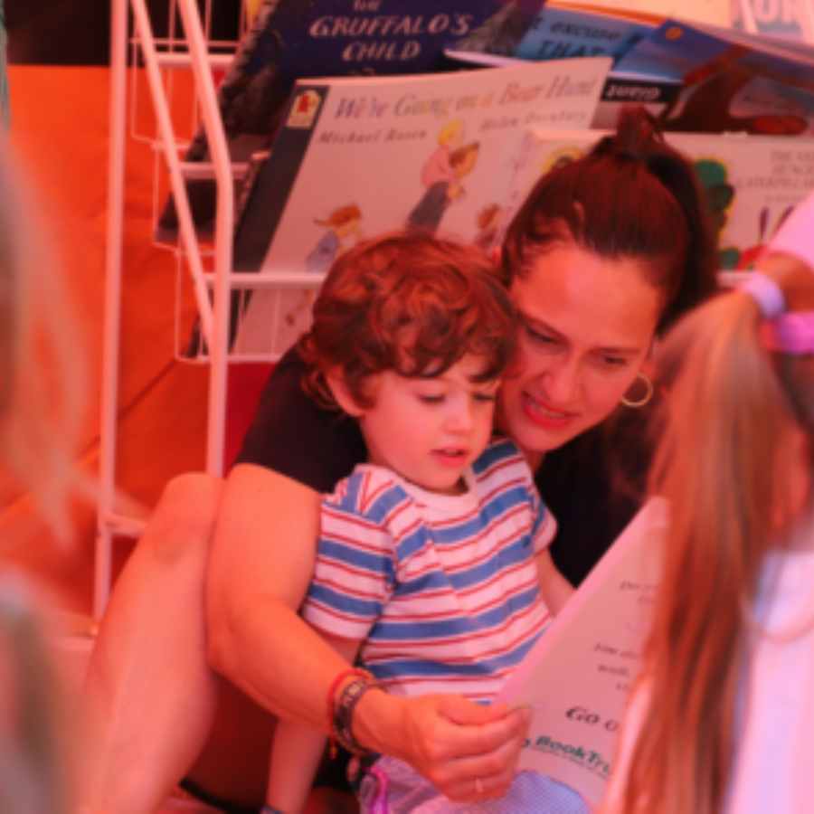 a bot and his mother reading a book